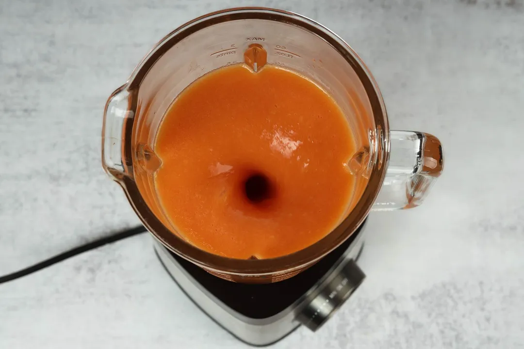 top view of mango and papaya smoothie in a blender