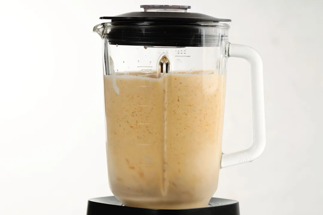 a blender pitcher of mango smoothie