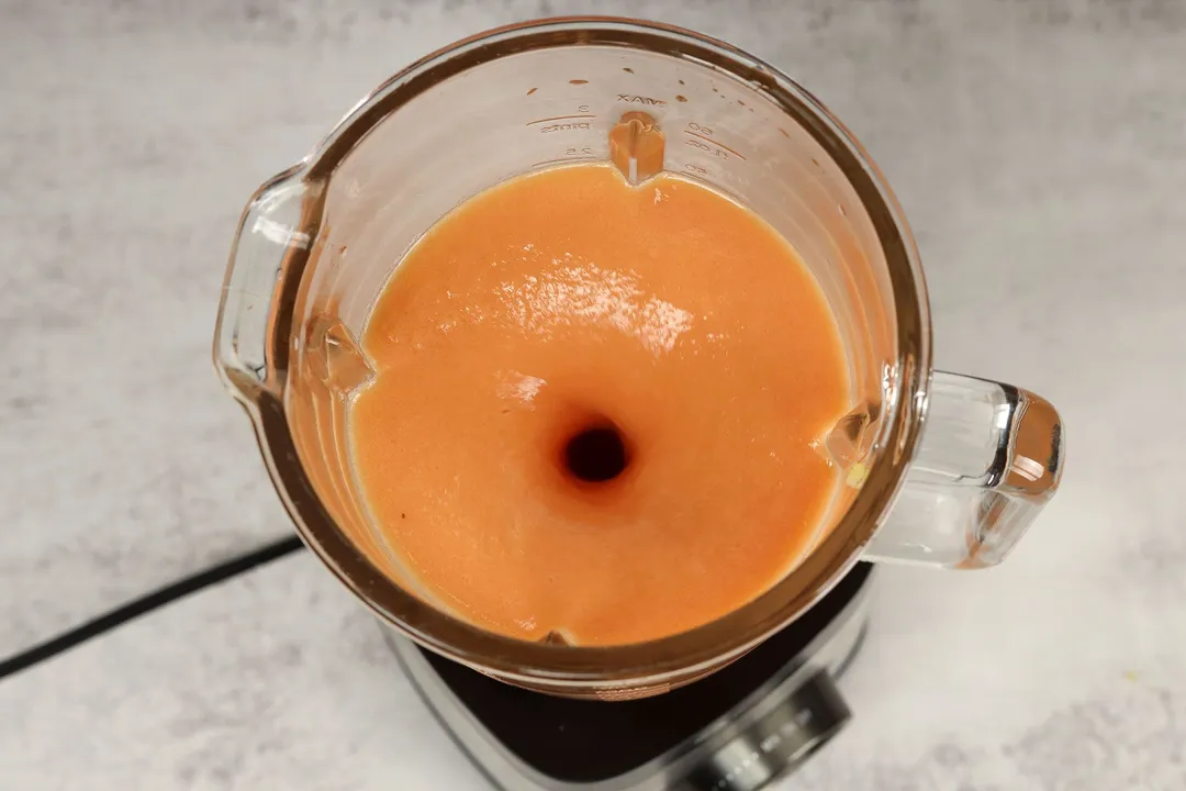 papaya and pineapple smoothie in a blender pitcher