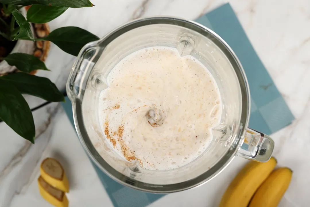 top view of Peanut Butter Banana Smoothie blending in a blender