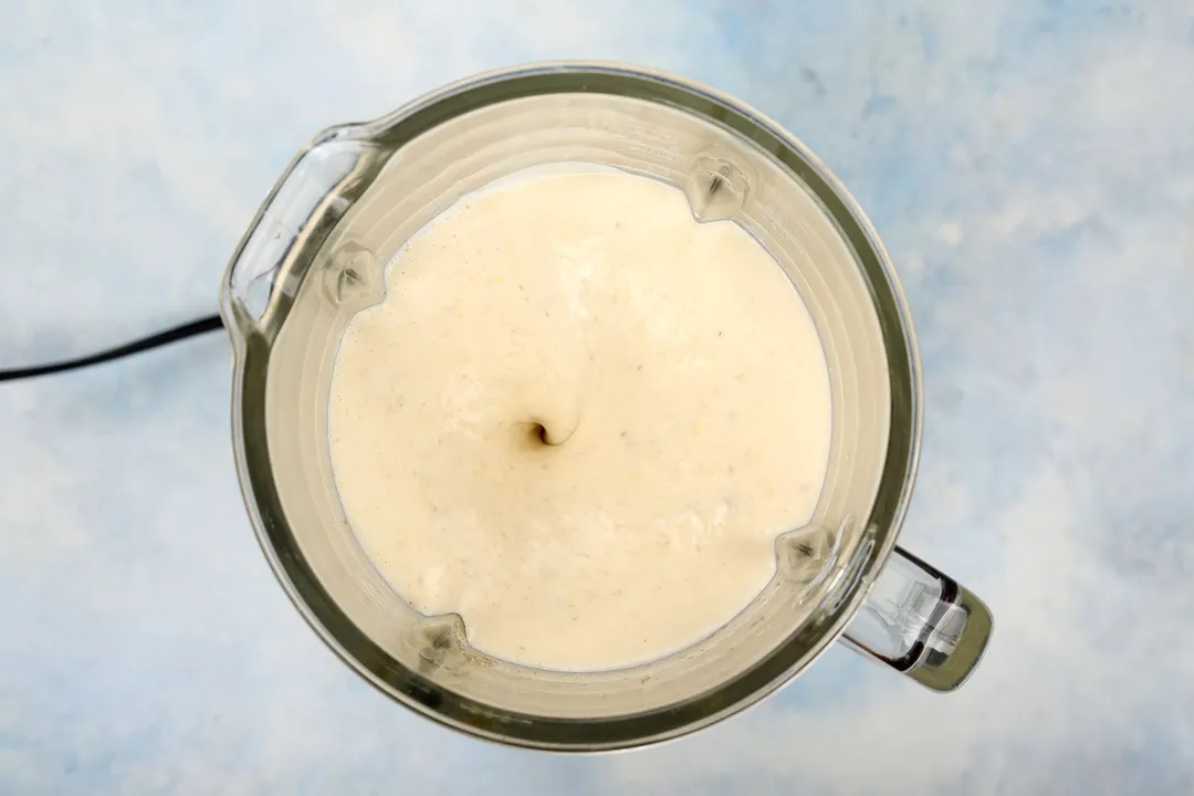 top view of a blender pitcher blending banana smoothie