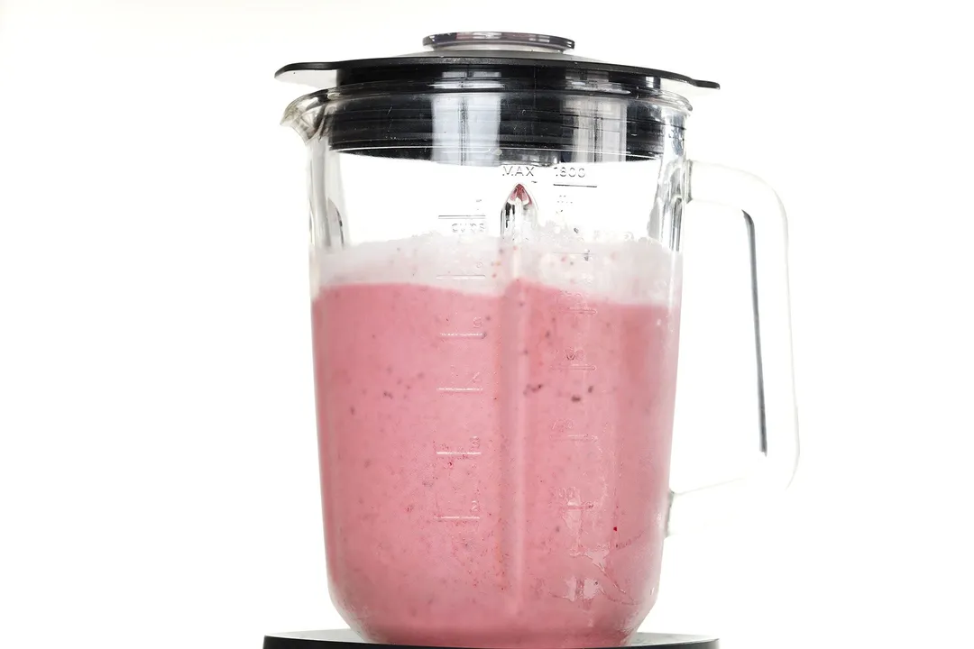 front shot of strawberries blackberries, blue berries smoothie in a blender pitcher