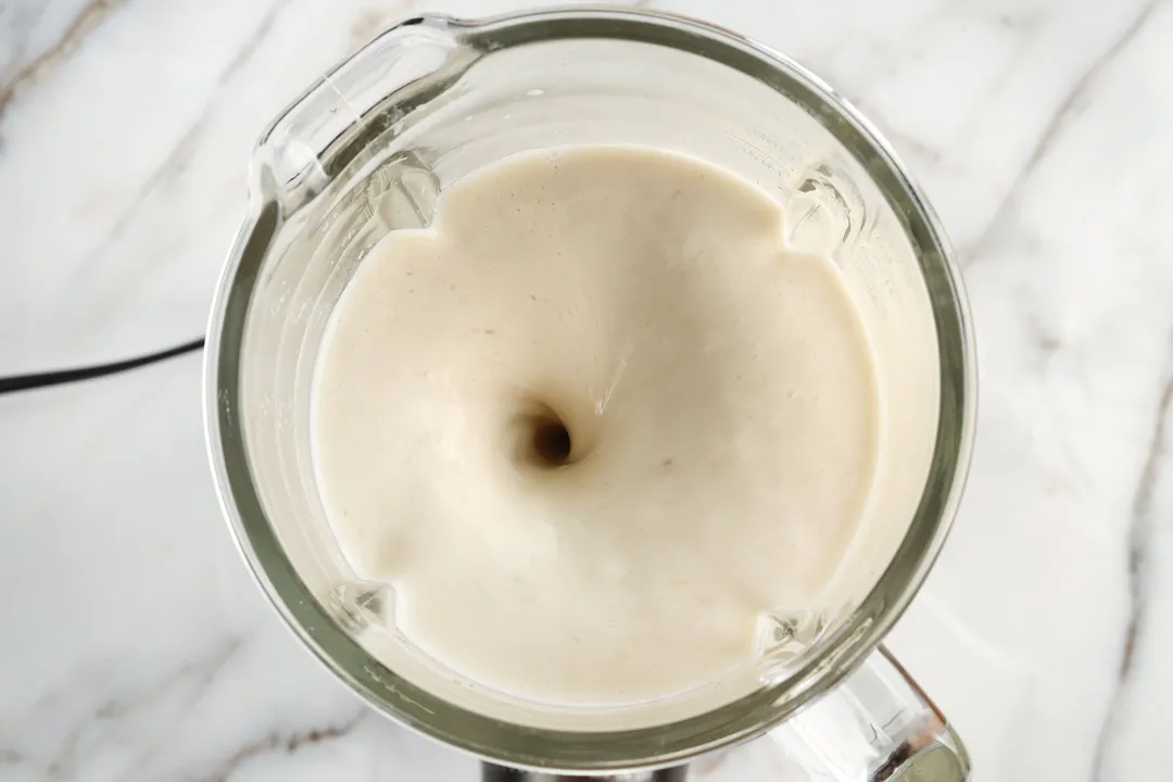 top view of a blender blending banana smoothie