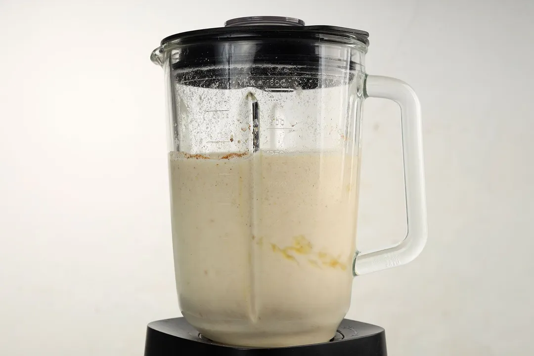 front shot of a blender pitcher with apple cinnamon smoothie in it
