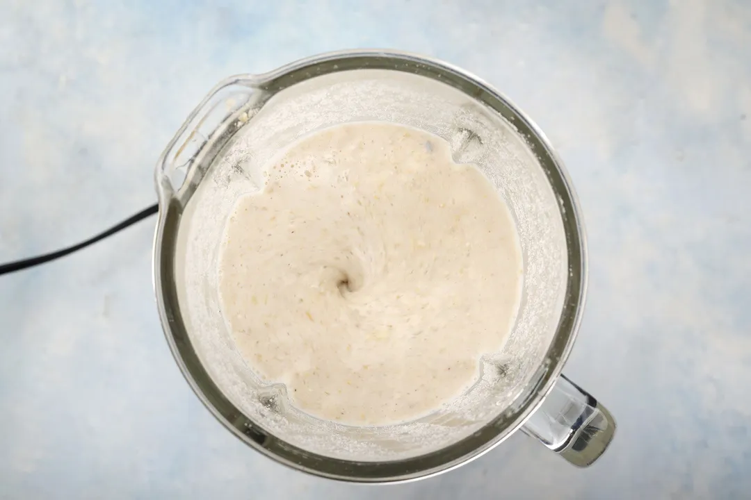 top view of a blender pitcher with banana oatmeal smoothie in it