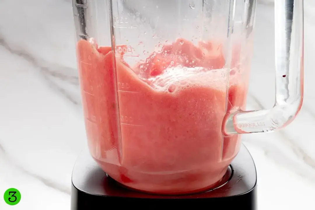 Watermelon smoothie being blended in a blender