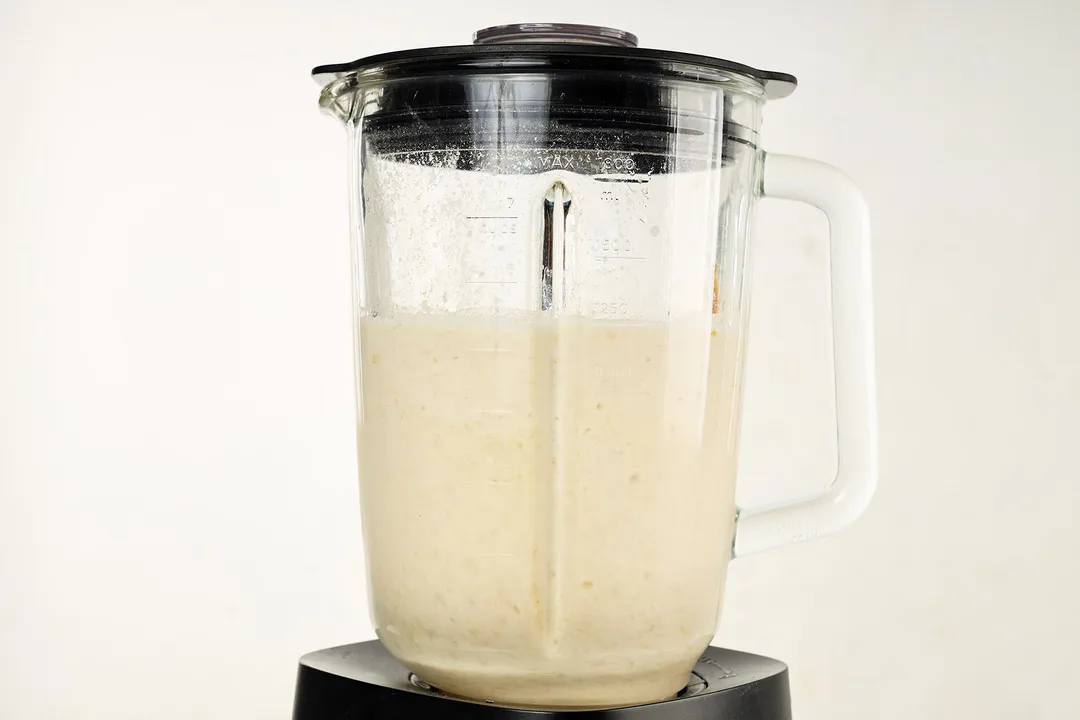 front shot of blender pitcher with peanut butter oatmeal smoothie in it