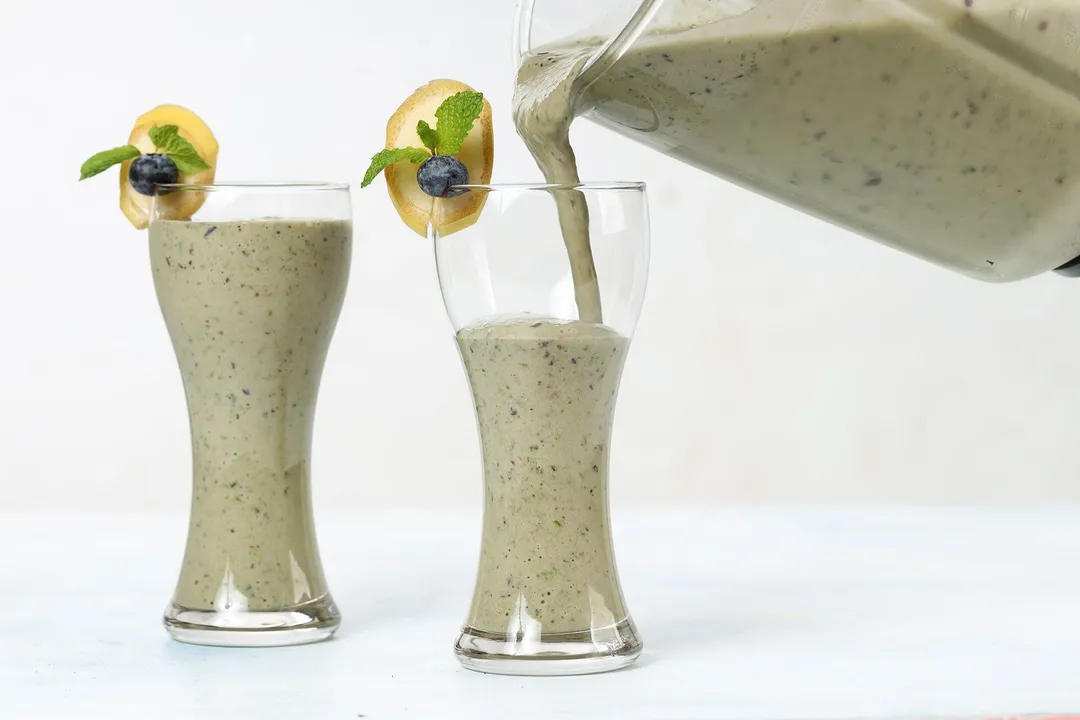 pouring smoothie from a pitcher into glasses