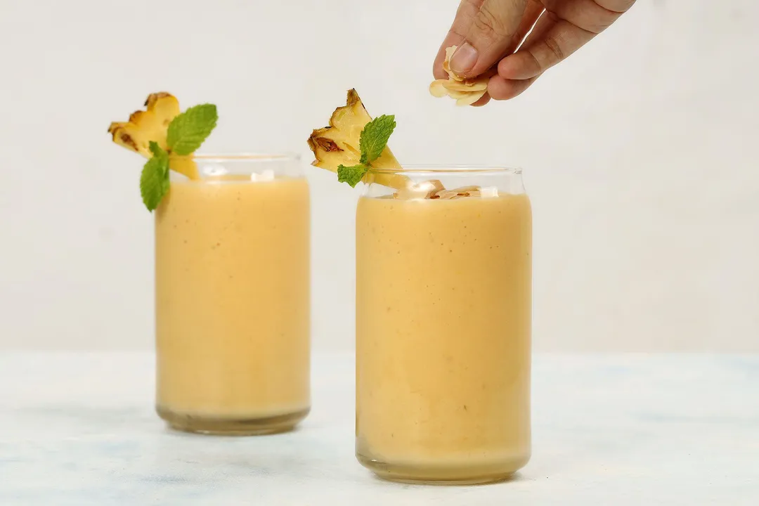 two glasses of mango pineapple smoothie