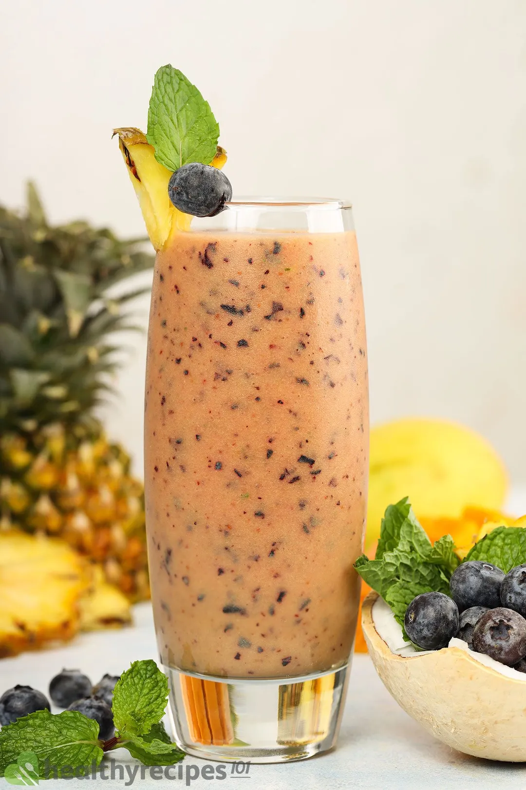 a glass of blueberry mango smoothie