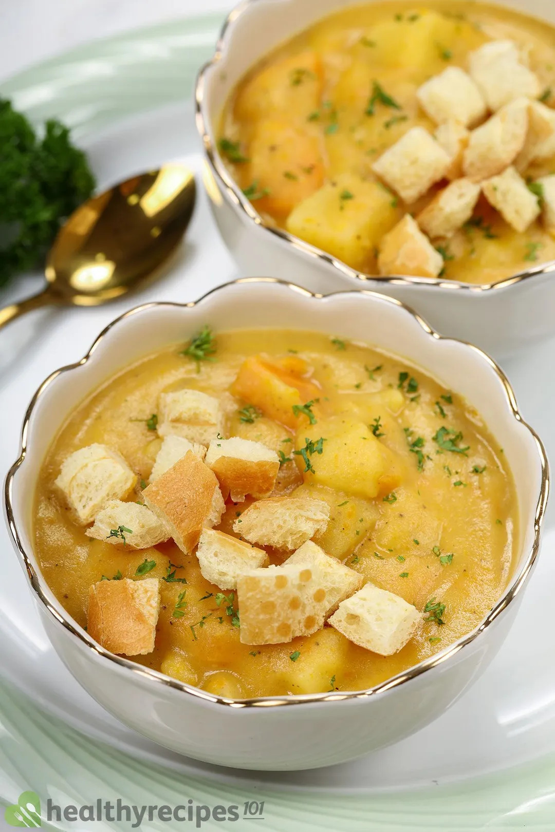 front shot of two bowls of potato soup