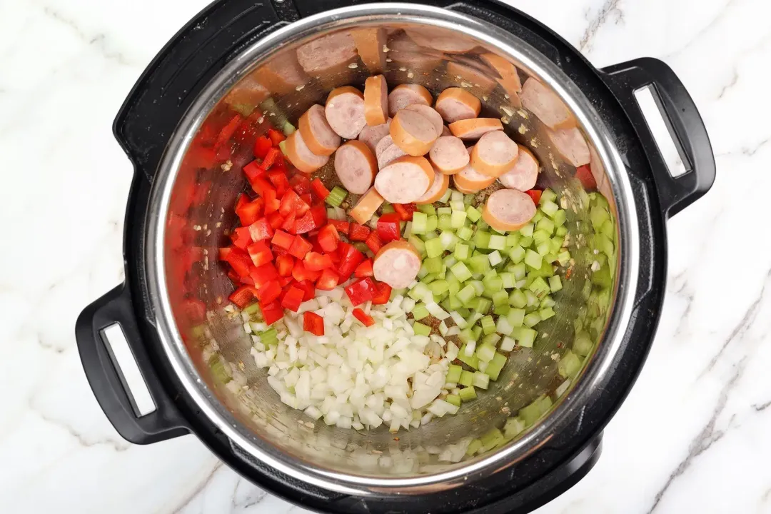 Saute the veggies and sausages with oil