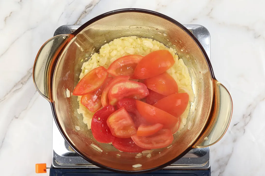 tomato wedge and diced tomato cooking in a pot