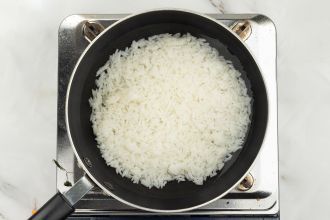 step 2: Simmer cooked rice with water until softened.