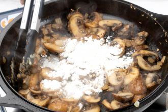 Add mushrooms and cook. Stir in flour quickly.