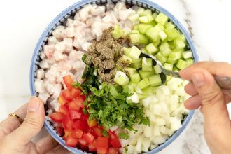 step 6: Add spices and vegetables to the ceviche bowl and mix together.