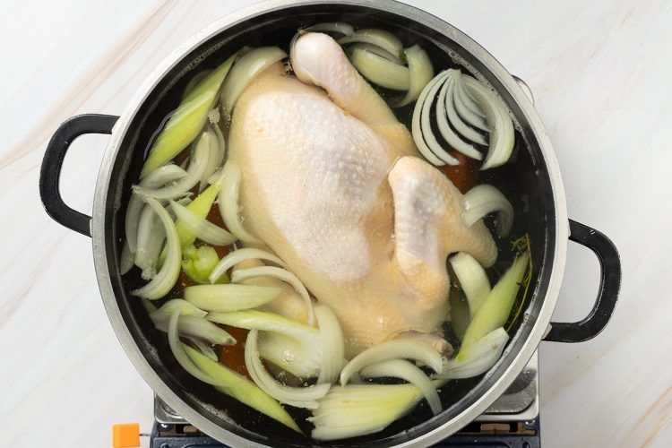 Step 3: Bring the water to a boil, add chicken, and simmer.