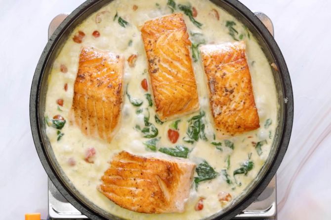 step 4: Add in cream sauce ingredients and seared salmon, and simmer