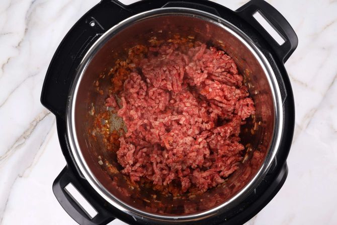 step 4: Add ground beef and quickly sauté until browned with no pink remains.