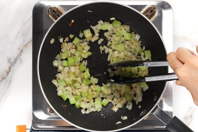 In a saucepan, sauté the vegetables with spices in butter and olive oil.