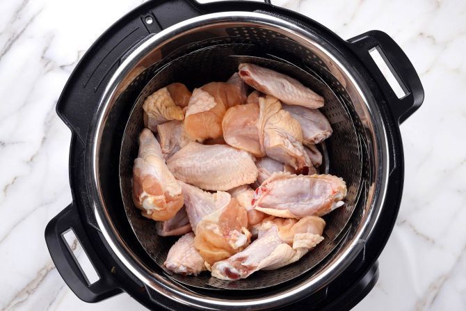 teamer basket inside the pot and put the chicken wings in