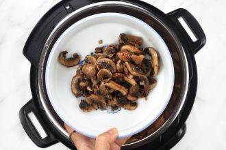 Step 3: Transfer half of the stir-fried mushrooms to a plate.