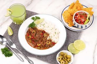 Step 10: Portion out the ropa vieja onto serving plates with cooked rice. Garnish with parsley and serve hot.