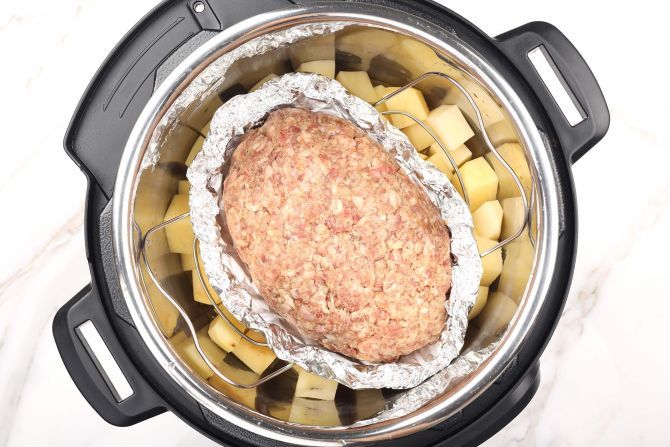 Step 4: Lay potatoes and meatloaf in the Instant Pot. cook
