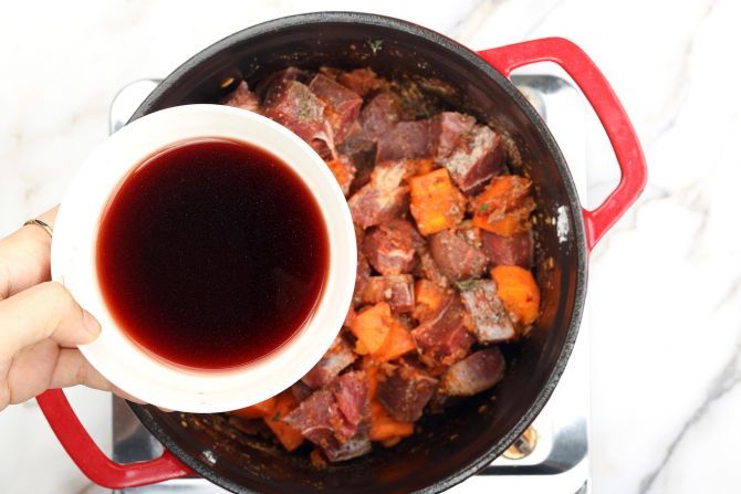 Step 5: Stir in the beef, seasoning, and red wine.