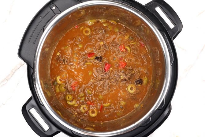 Step 9: Add the green olives and return the pulled beef to the pot. Cook on “Sauté” for 10 minutes.