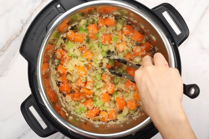 Sauté the vegetables and rice.