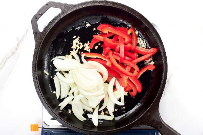 Stir-fry onion and red bell pepper.