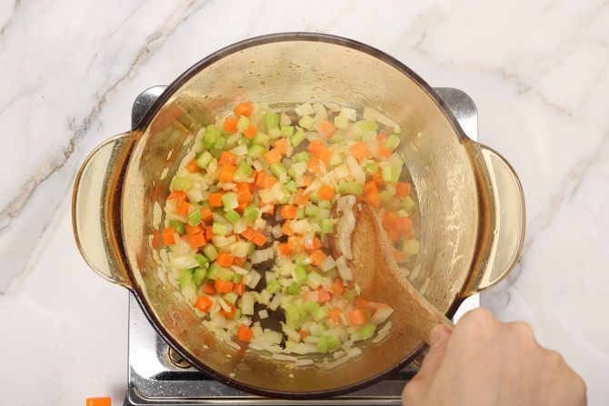 step 2: Add the onions, celery, and carrots.