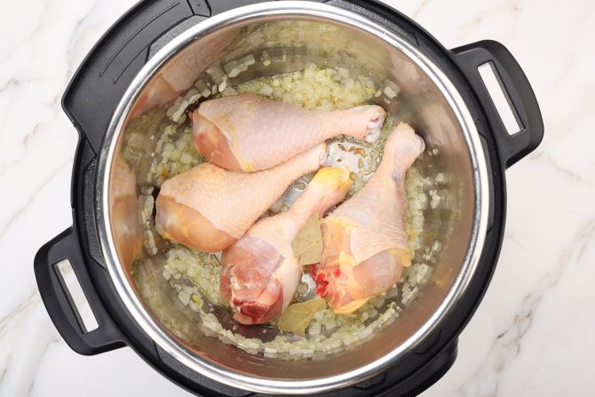Step 3: Add the chicken drumstick. Stir.