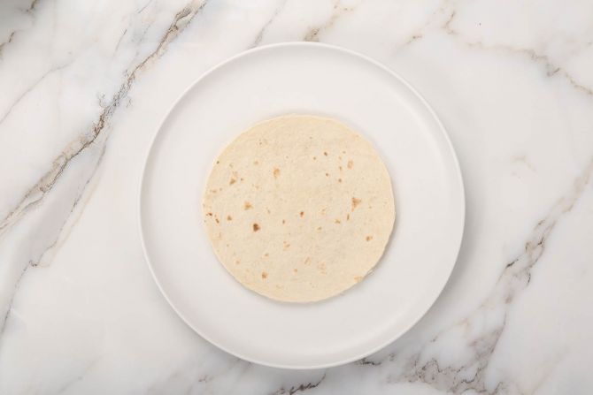 Step 4: Place a tortilla on a flat surface.
