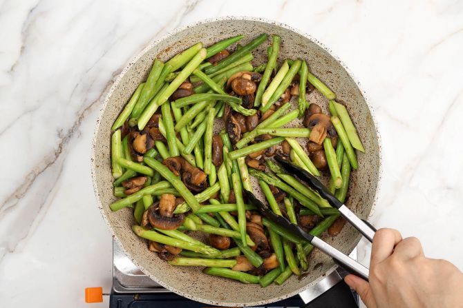 step 5: Add asparagus and green beans to sauté.