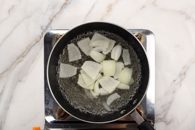 Step 1: Bring a pot of water to a boil with yellow onion.