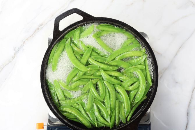 step 2: Blanch the snow peas and shock them in ice water afterward.