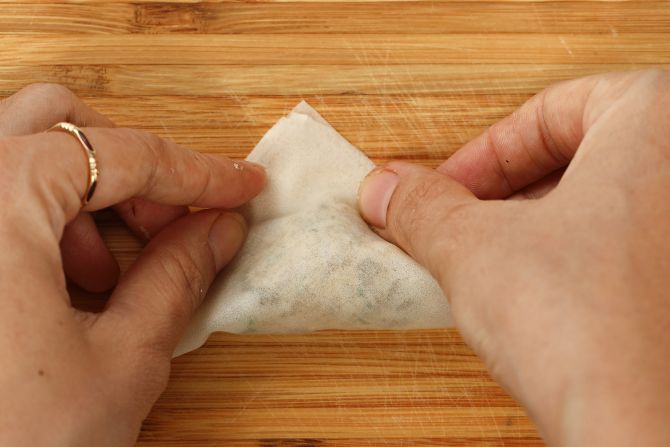step 3: Place a small amount of filling onto the wrap. Wet the edges and fold.