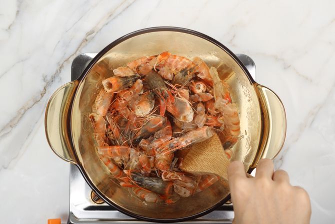 step 1: In a stockpot, sauté shrimp shells in olive oil over medium heat.