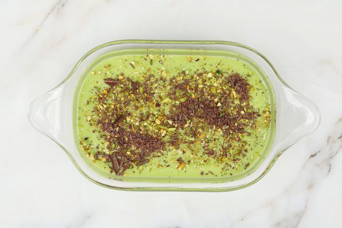Step 2: Pour the mixture into a container, and sprinkle crushed pistachio nuts and dark chocolate on top.