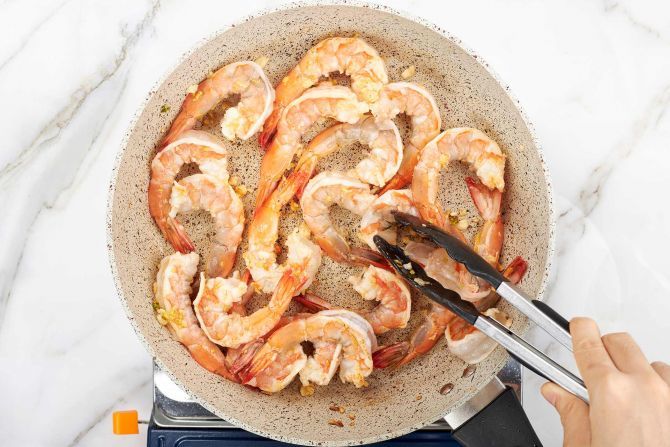 Step 4: Add the shrimp. Stir-fry until they turn pink.