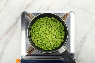 Step 1: Bring a pot of water to a boil, add edamame, and cook for 3 minutes. Drain and rinse with cold water.