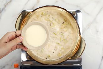 step 5: Remove the soup pot from the heat and stir in 2 tbsp heavy cream.